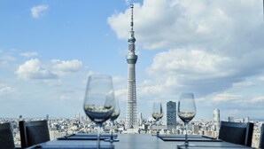 A table with three wine glasses and a cityscape view including a tall tower. - Tobu Hotel Levant Tokyo (Tokyo)