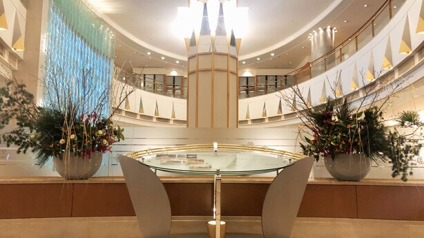 A modern atrium with a central glass table, surrounded by tiered seating and large potted plants. - Tobu Hotel Levant Tokyo (Tokyo)