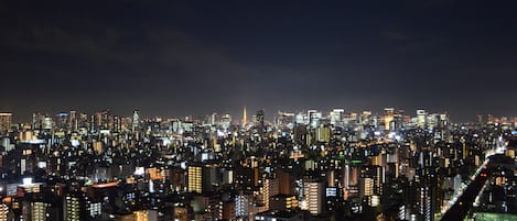 A nighttime cityscape with densely packed buildings and bright lights.