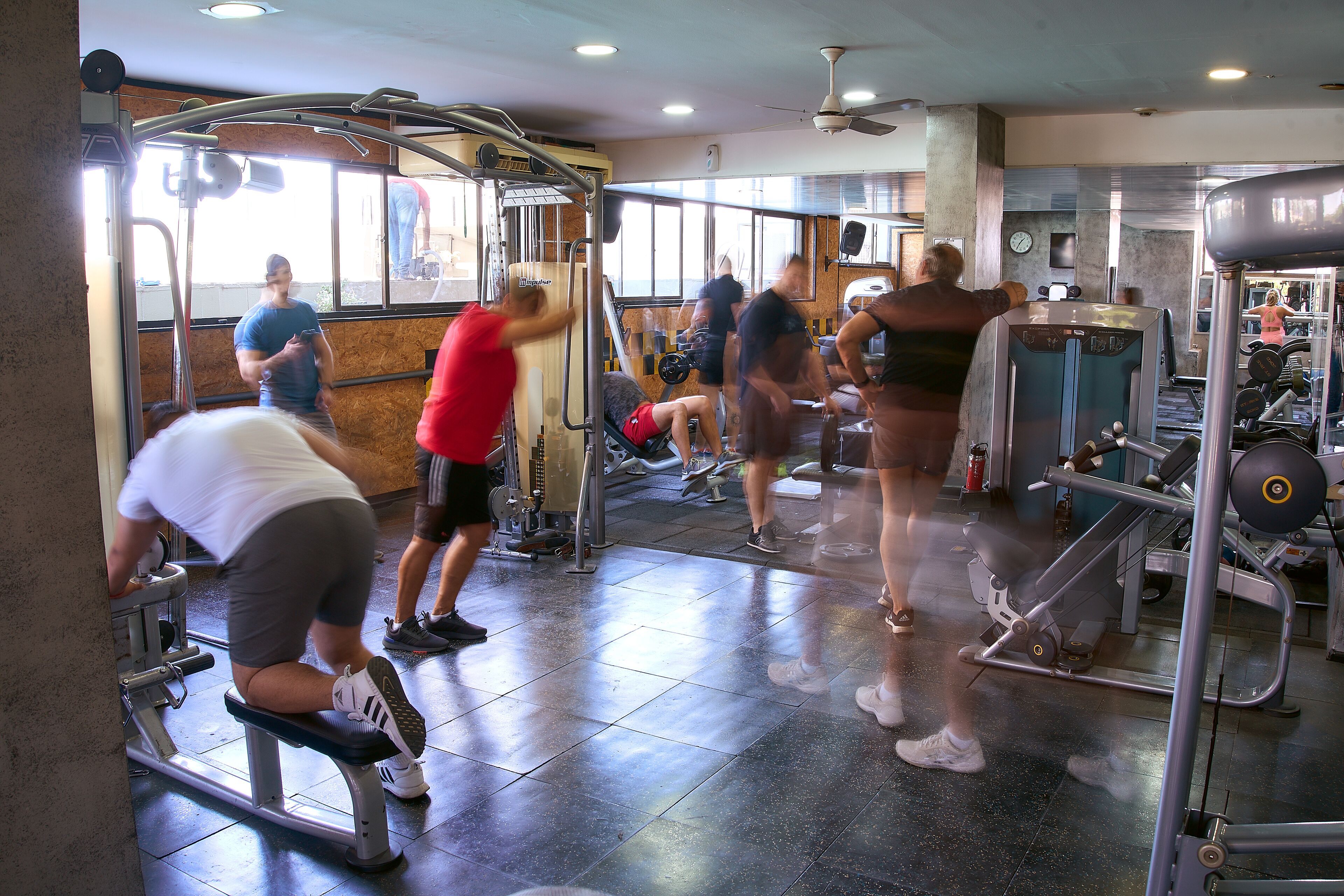 A gym with various exercise equipment, including treadmills and weight machines.