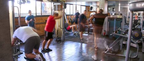 A gym with various exercise equipment, including treadmills and weight machines.