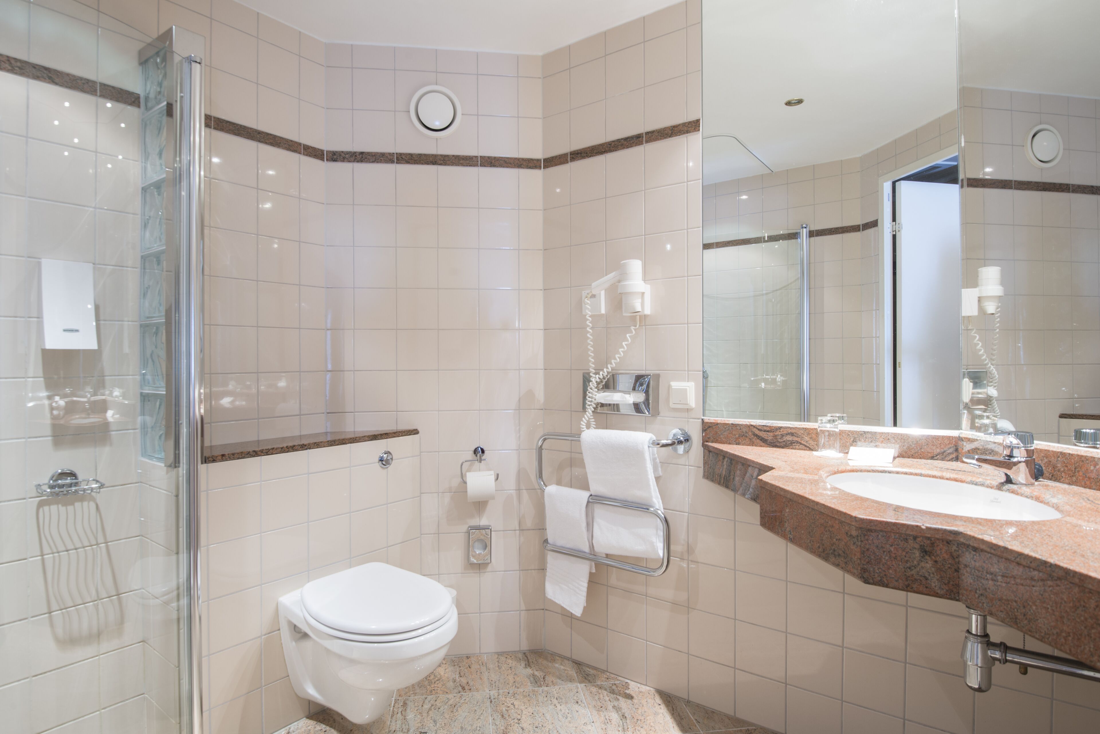 designer toiletries, hair dryer, towels, soap