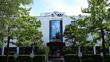 Ein Hotel mit modernem Design, das eine große Glasfassade und ein Schild mit der Aufschrift "ECONTEL HOTEL" zeigt.
