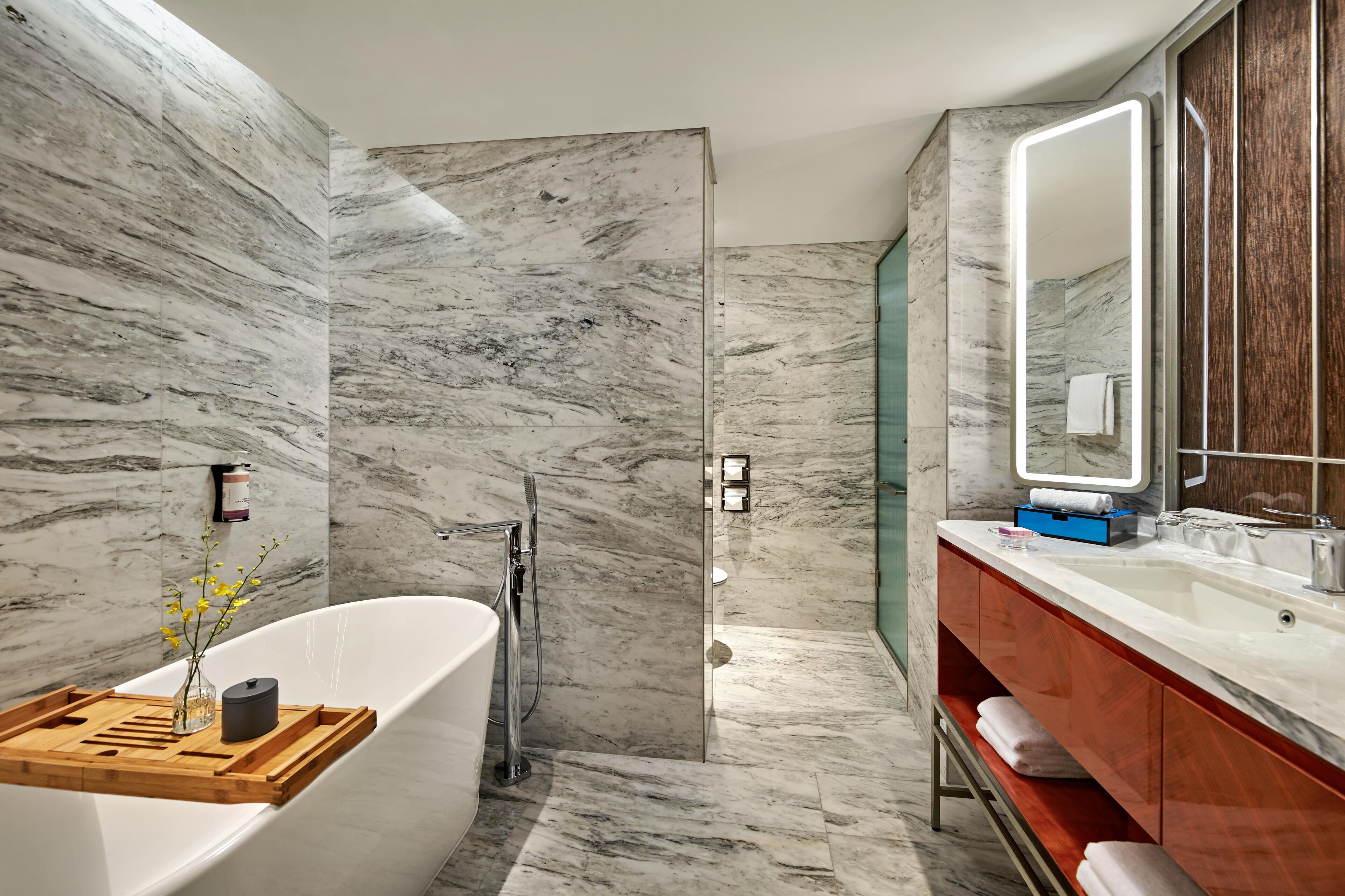 deluxe room, 1 king bed | bathroom | rainfall showerhead, eco-friendly toiletries, hair dryer, bathrobes