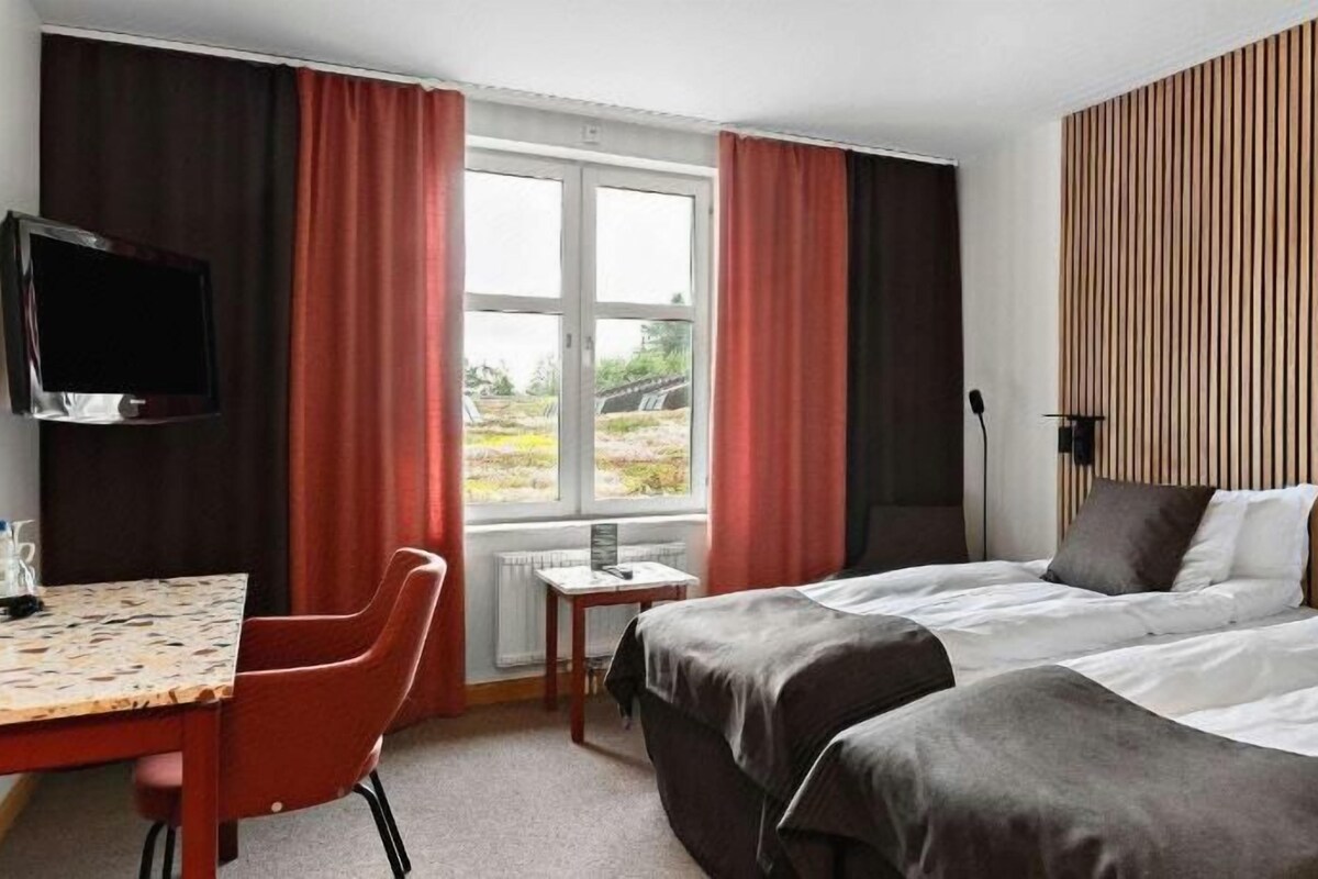 Premium bedding, laptop workspace, blackout curtains, soundproofing