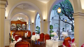 A restaurant with a classic European architectural style, featuring arched ceilings and a central bar area.