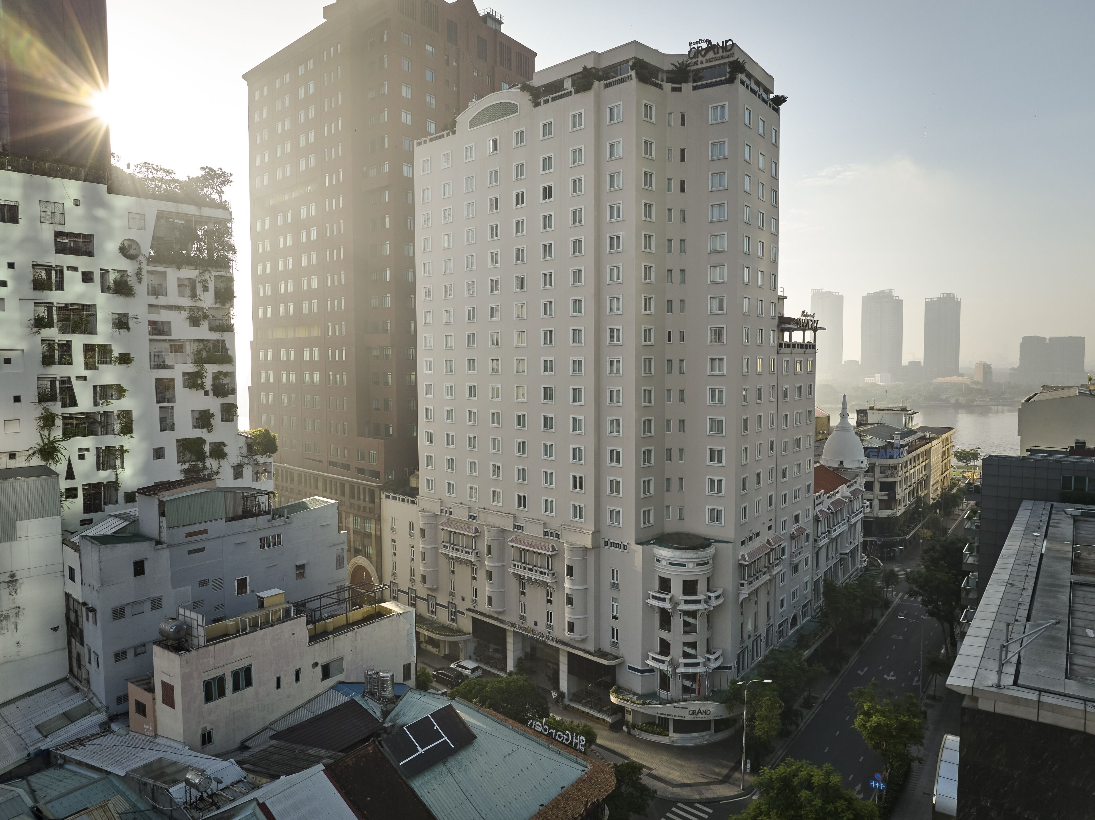 A high-rise building with multiple floors, large windows, and a central courtyard.