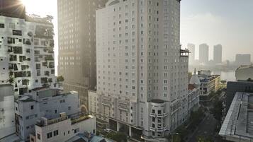 A high-rise building with multiple floors, large windows, and a central courtyard.
