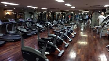 A gym with multiple treadmills and exercise equipment.