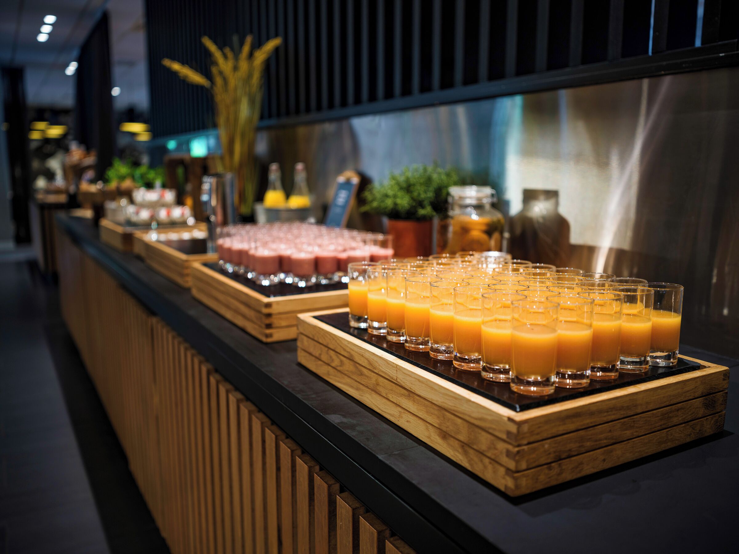 A buffet counter with various food items and drinks.