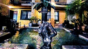 A courtyard with a central fountain, a multi-story building with balconies, and potted plants. - Hotel Baja San Diego - A Boutique Hotel (San Ysidro)