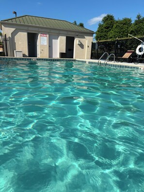A clear swimming pool with a lifebuoy and a signboard. - Baymont by Wyndham Johnson City (Johnson City)