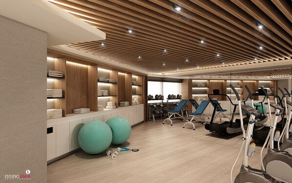A modern gym with exercise equipment, weightlifting areas, and neatly arranged towels. - Holiday Inn Ciudad Juarez by IHG (Ciudad Juárez)