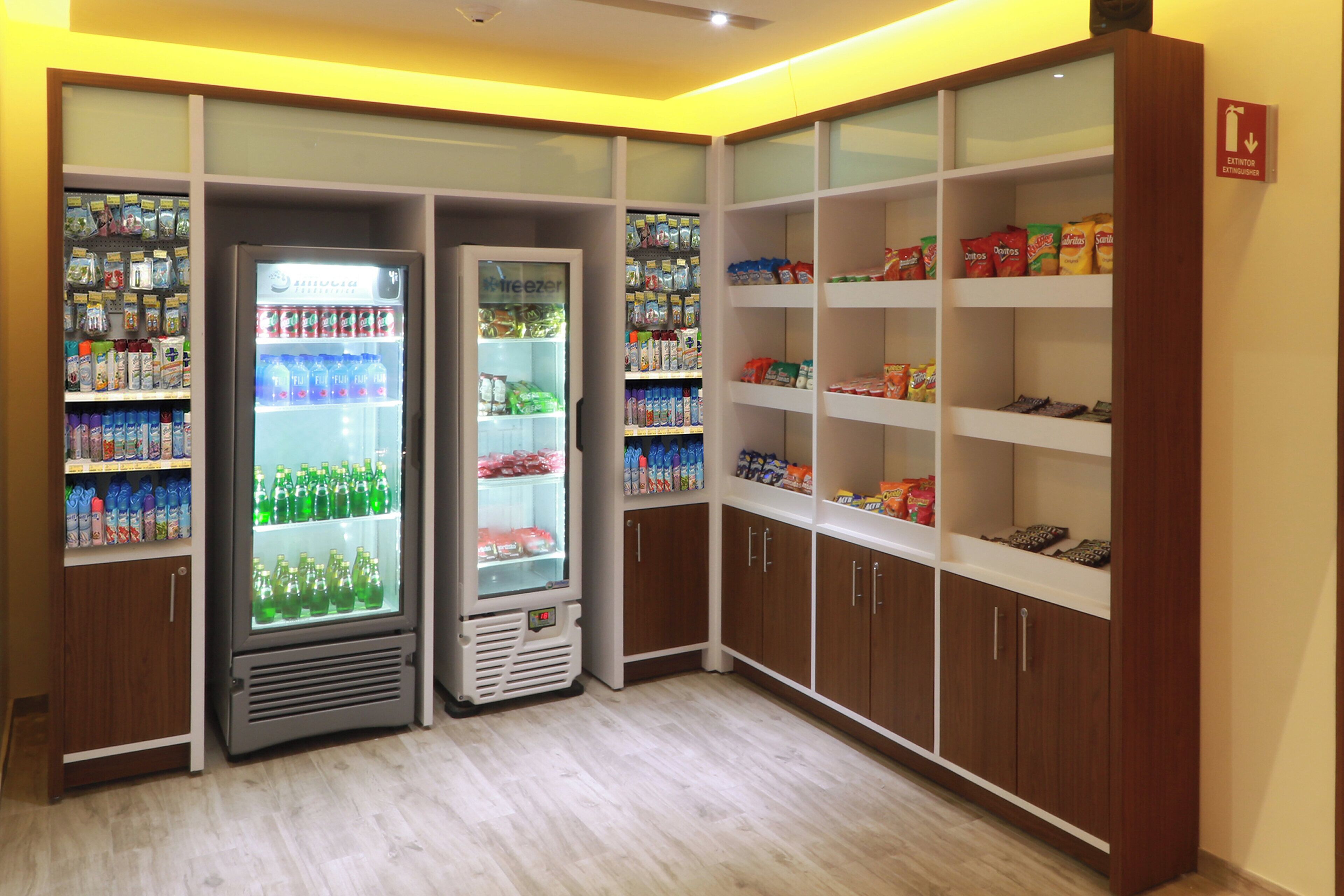 A vending area with multiple beverage dispensers and snack shelves.