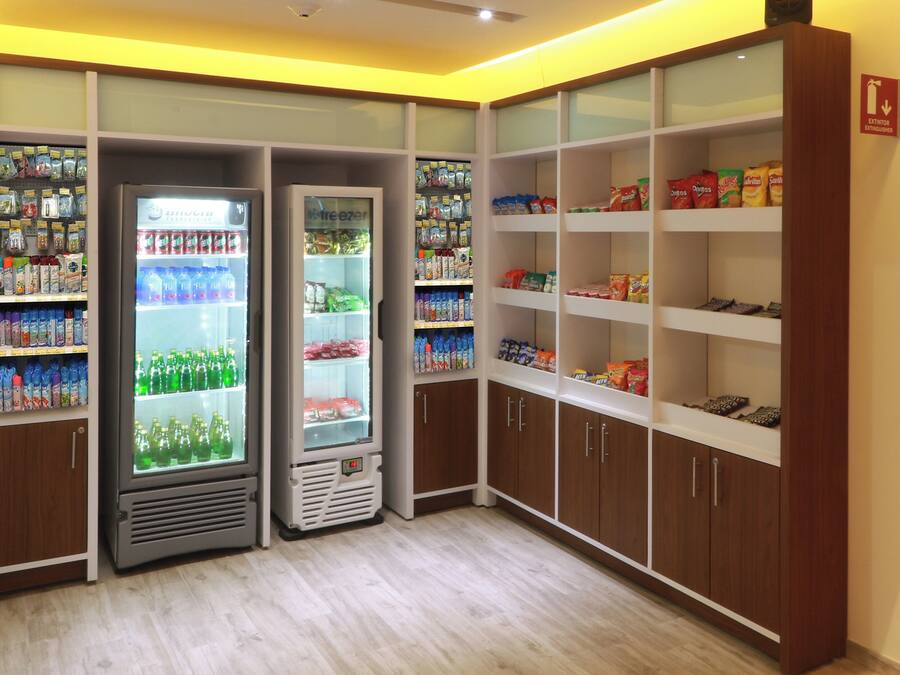 A vending area with multiple beverage dispensers and snack shelves.