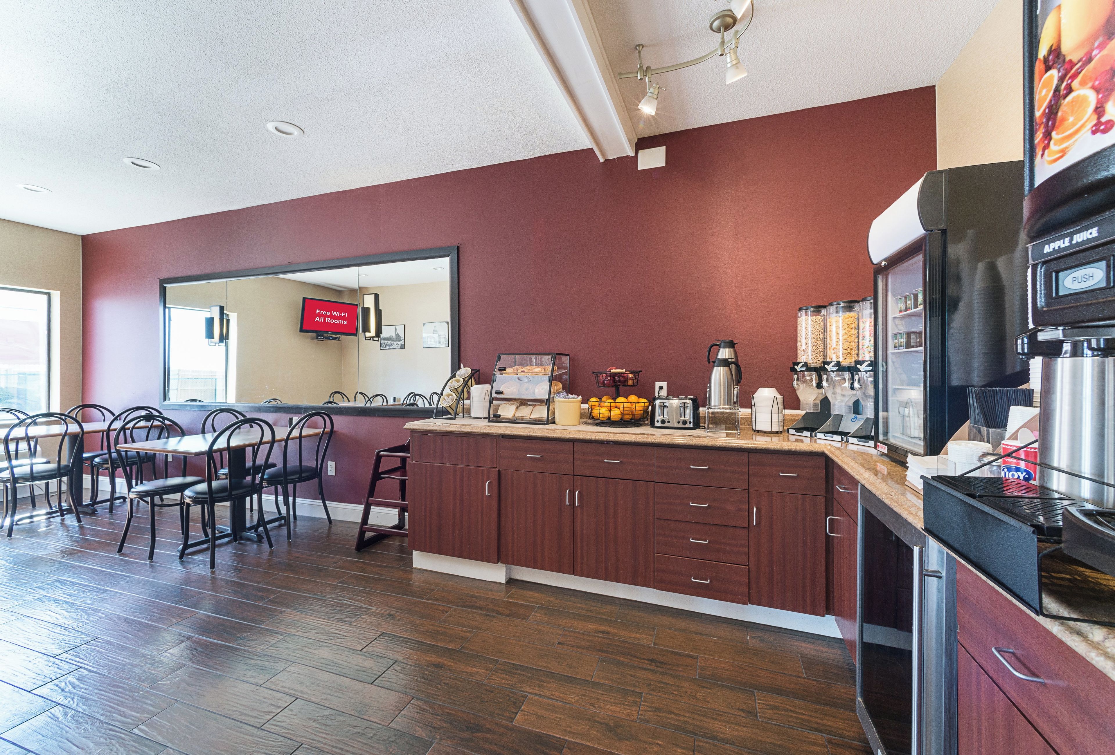 A modern kitchen with a marble countertop, wooden cabinets, and a coffee machine.
