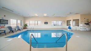 An indoor swimming pool with clear water, surrounded by lounge chairs and a no diving sign. - Red Roof Inn St Louis - Troy, IL (Troy)