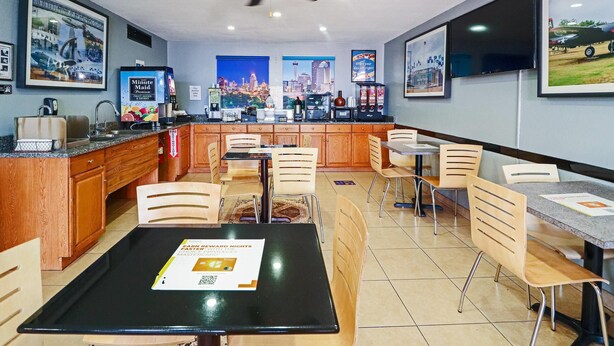 A restaurant with a bar area, multiple seating options, and a cityscape view.