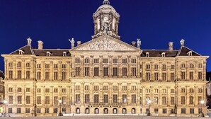 A large, historic building with a prominent dome and statues on the roof. - ibis Amsterdam Centre Stopera (Amsterdam)