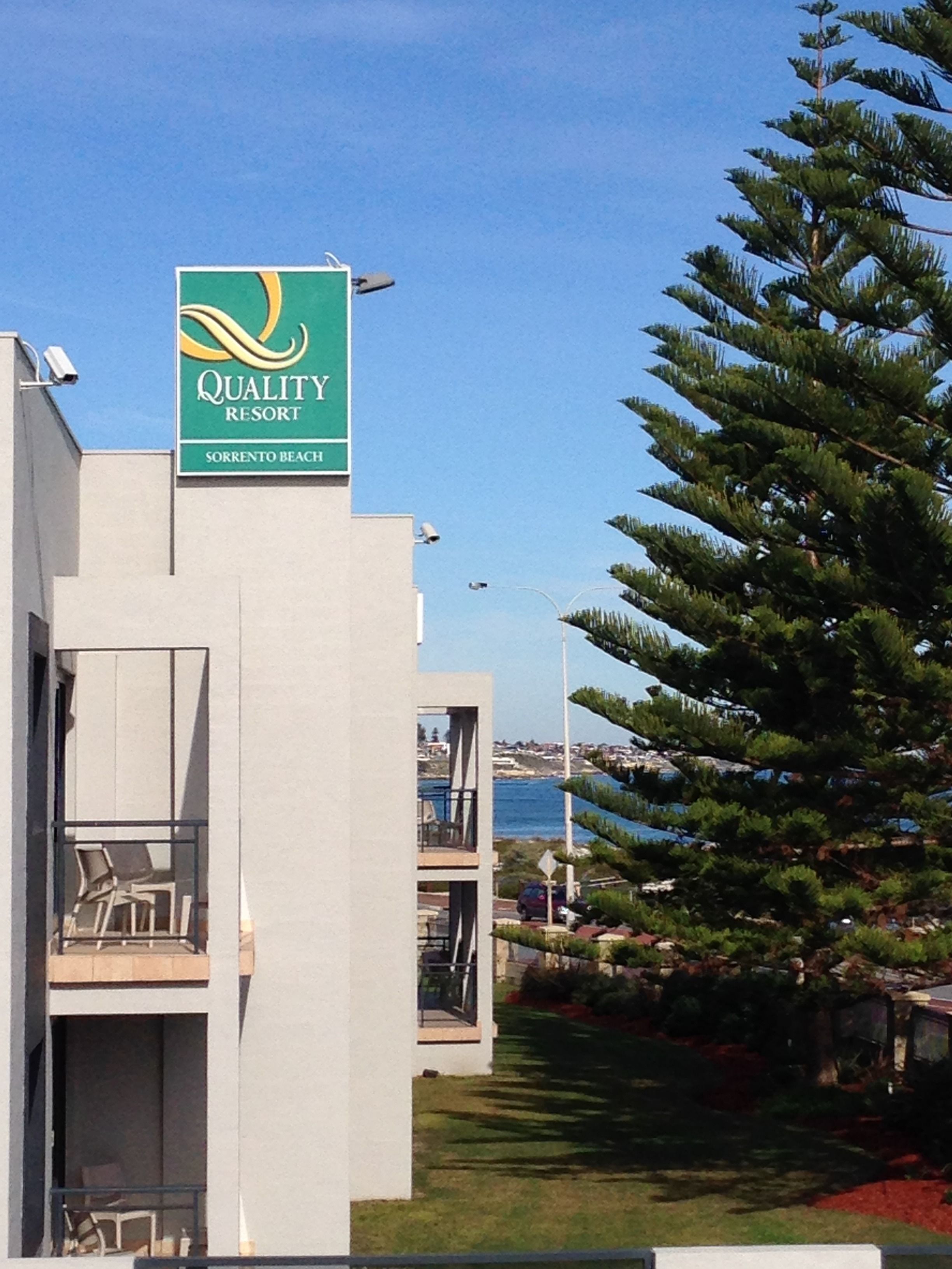 A building with a sign for Quality Resort at Sorrento Beach.