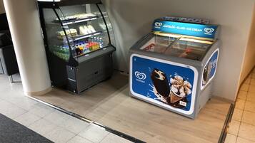 A glass display case with snacks and a refrigerated ice cream display.