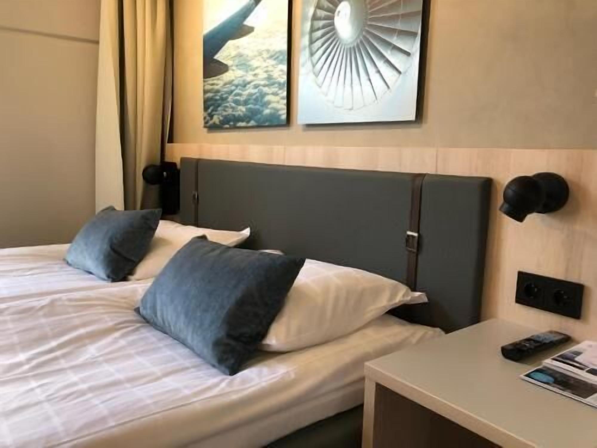 Hypo-allergenic bedding, desk, laptop workspace, blackout drapes