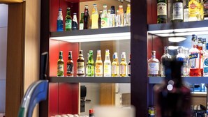 A bar area with shelves stocked with various liquor bottles and glasses. - Good Morning Mölndal (Mölndal)