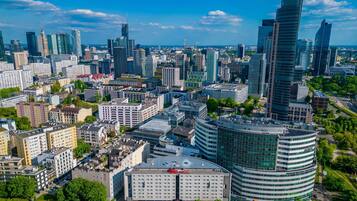 A modern cityscape with a prominent hotel featuring a curved facade and a flat roof.