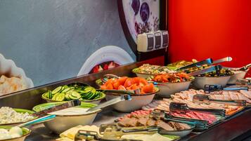 A buffet with various food options including salads, meats, and cheeses.