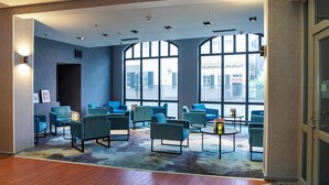 A hotel lobby with a seating area, large windows, and a modern design. - ACHAT Hotel Heppenheim (Heppenheim)