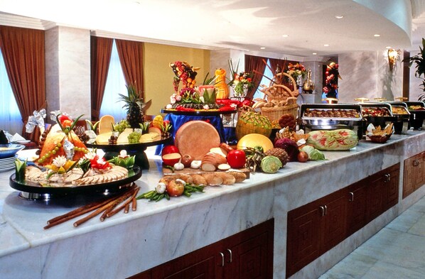 A buffet with various food items and decorations.