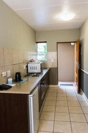 Habitación doble superior, varias camas | Cocina privada | Frigorífico, microondas, placa de cocina y cafetera o tetera