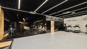 A modern gym with weightlifting equipment, treadmills, and a clean, minimalist design. - Peace Hotel Beijing (Beijing)