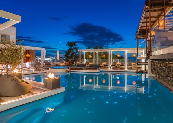 Relax by the pool surrounded by comfortable lounge chairs and a seating area.