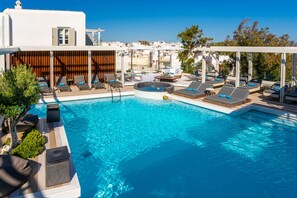 Relax by the rooftop pool with city views, lounge chairs, and a hot tub.