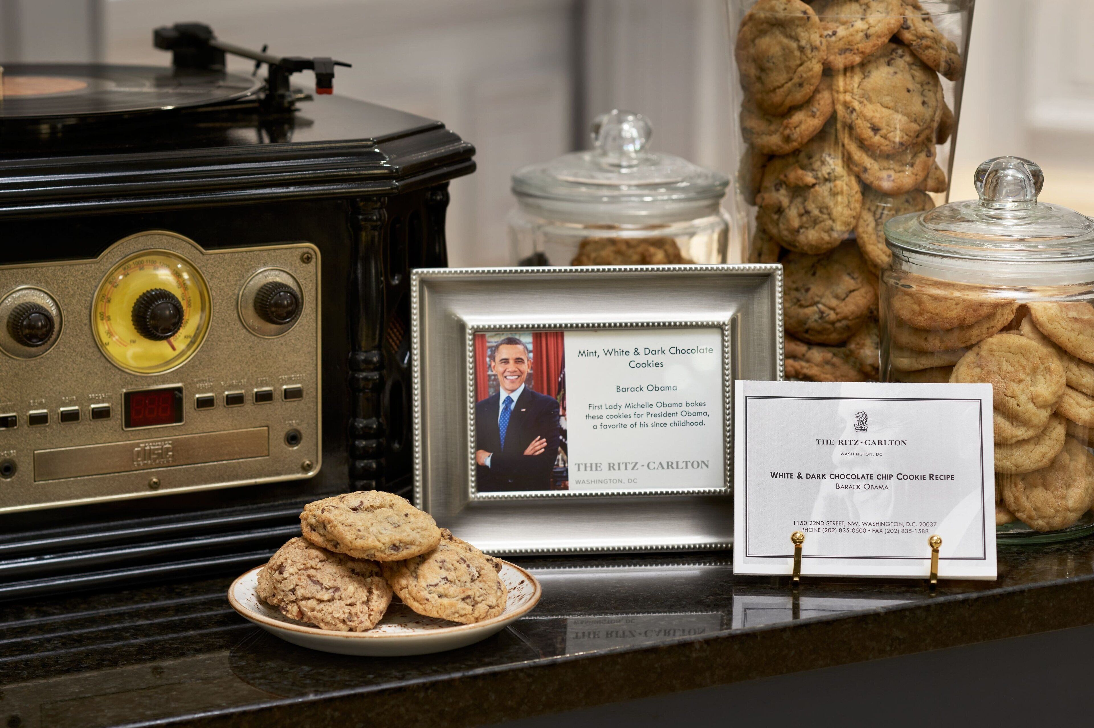 A vintage radio, a framed photo, a cookie jar, and a recipe card on a counter.