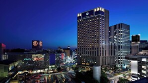 A high-rise hotel with a prominent sign, multiple floors, and a modern design.