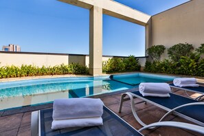 Outdoor pool, open 7 AM to 10 PM, pool loungers