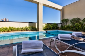 Outdoor pool, open 7 AM to 10 PM, pool loungers