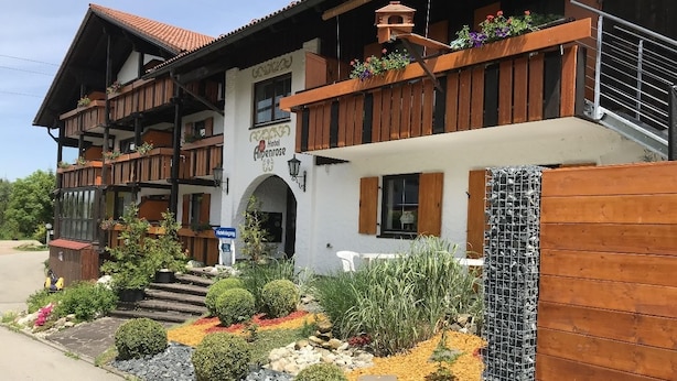 A traditional wooden building with a sign indicating it is a hotel. - AKZENT Hotel Alpenrose (Nesselwang)