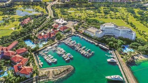 An aerial view of a resort with a marina, golf course, and hotel buildings. - The Pacific Sutera Hotel (Kota Kinabalu)