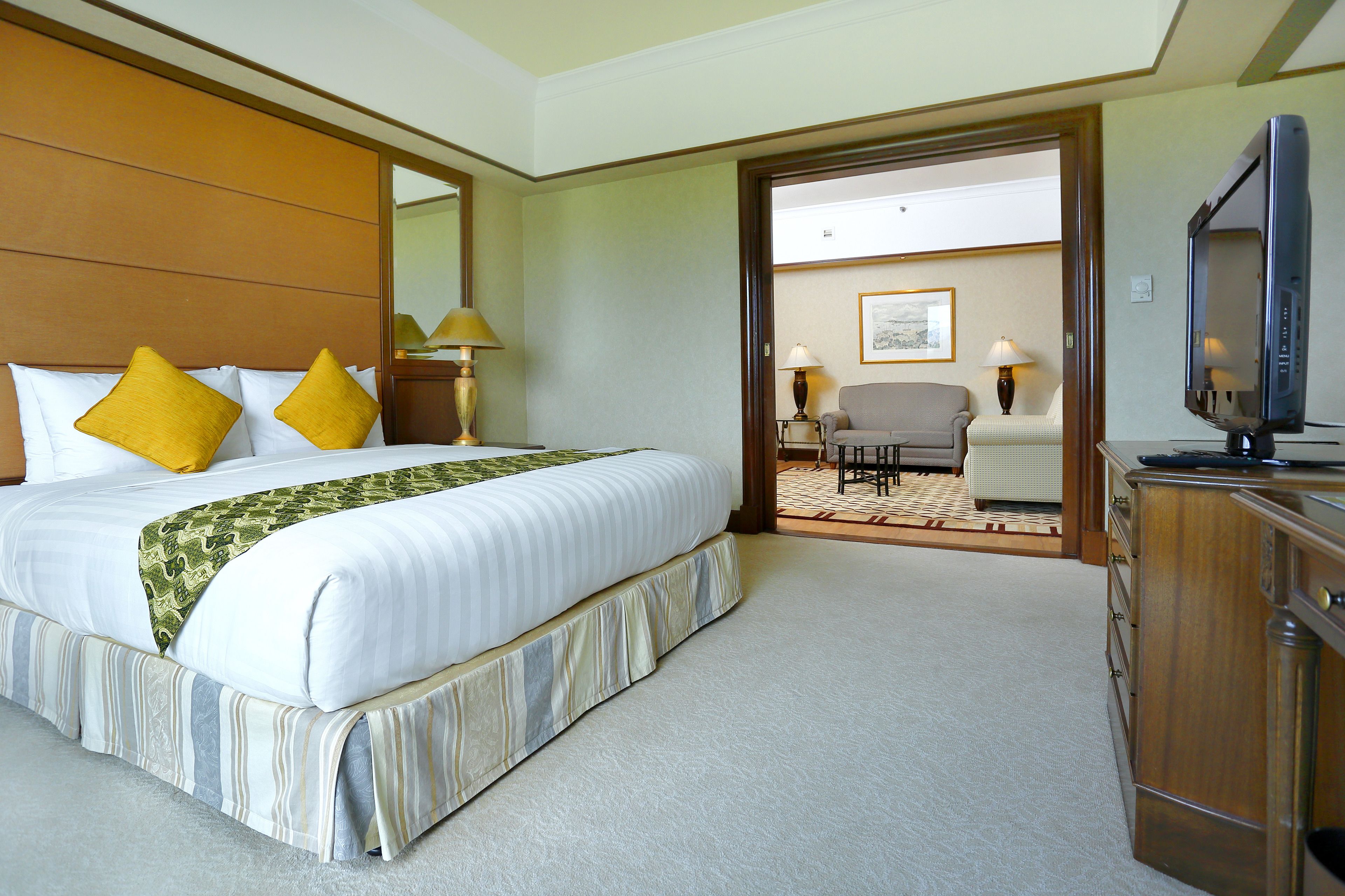 Une chambre d’hôtel avec un grand lit, une télévision et un bureau.