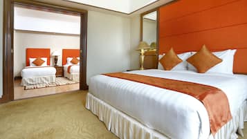 A hotel room with a large bed, a mirror, and a view of another room.