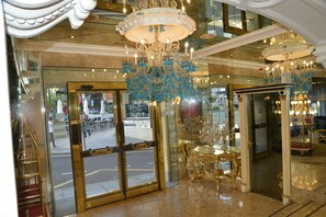 A grand lobby with a large chandelier, a glass entrance, and a staircase. - B&B HOTEL Salamanca Centro Artheus (Salamanca)