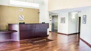 A hotel reception area with a wooden floor, a reception desk, and an elevator. - Sleep Inn Tinley Park I-80 near Amphitheatre-Convention Center (Tinley Park)