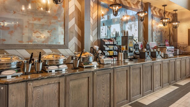 A buffet area with various food stations, including a hot pot and a salad bar. - Best Western Plus Silver Saddle Inn (Estes Park)