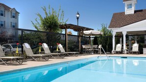 A swimming pool with lounge chairs and a pergola. - Sonesta Simply Suites Seattle Renton (Renton)