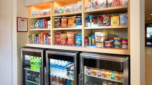 A snack and beverage display with various products and two refrigerated cases. - Sonesta Simply Suites Seattle Renton (Renton)