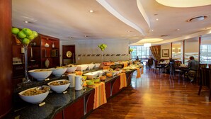 A buffet setup with various food items and a long counter.