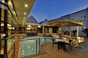 A pool area with a bar, seating, and umbrellas. - City Lodge Johannesburg Airport, Barbara Road (Edenvale)